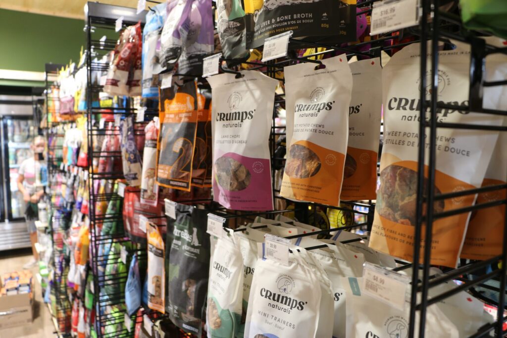 Selection of dog treats and natural chews on display at The Paw Shop