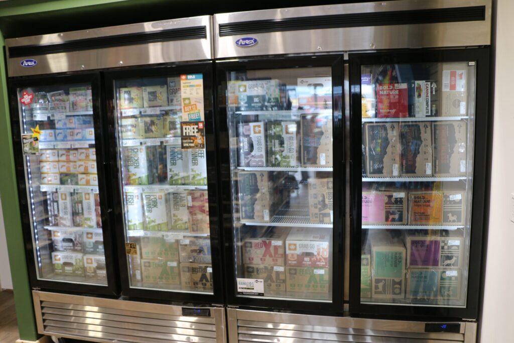 Freezers stocked with frozen and raw pet food at The Paw Shop in Cranbrook